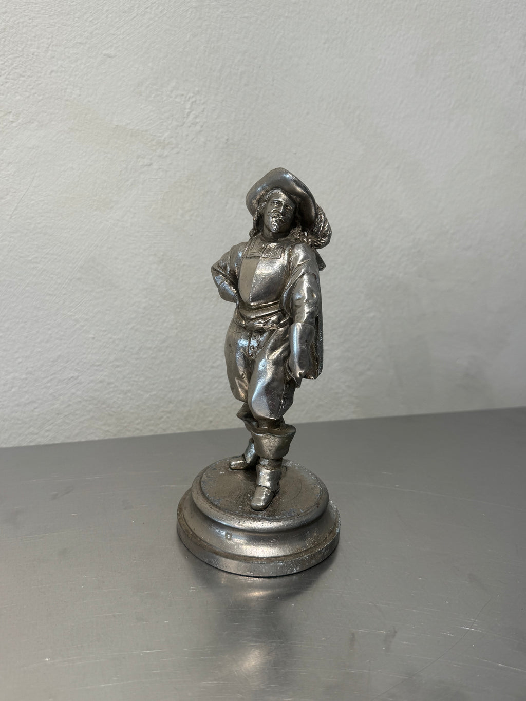 Antique metal musketeer figurine