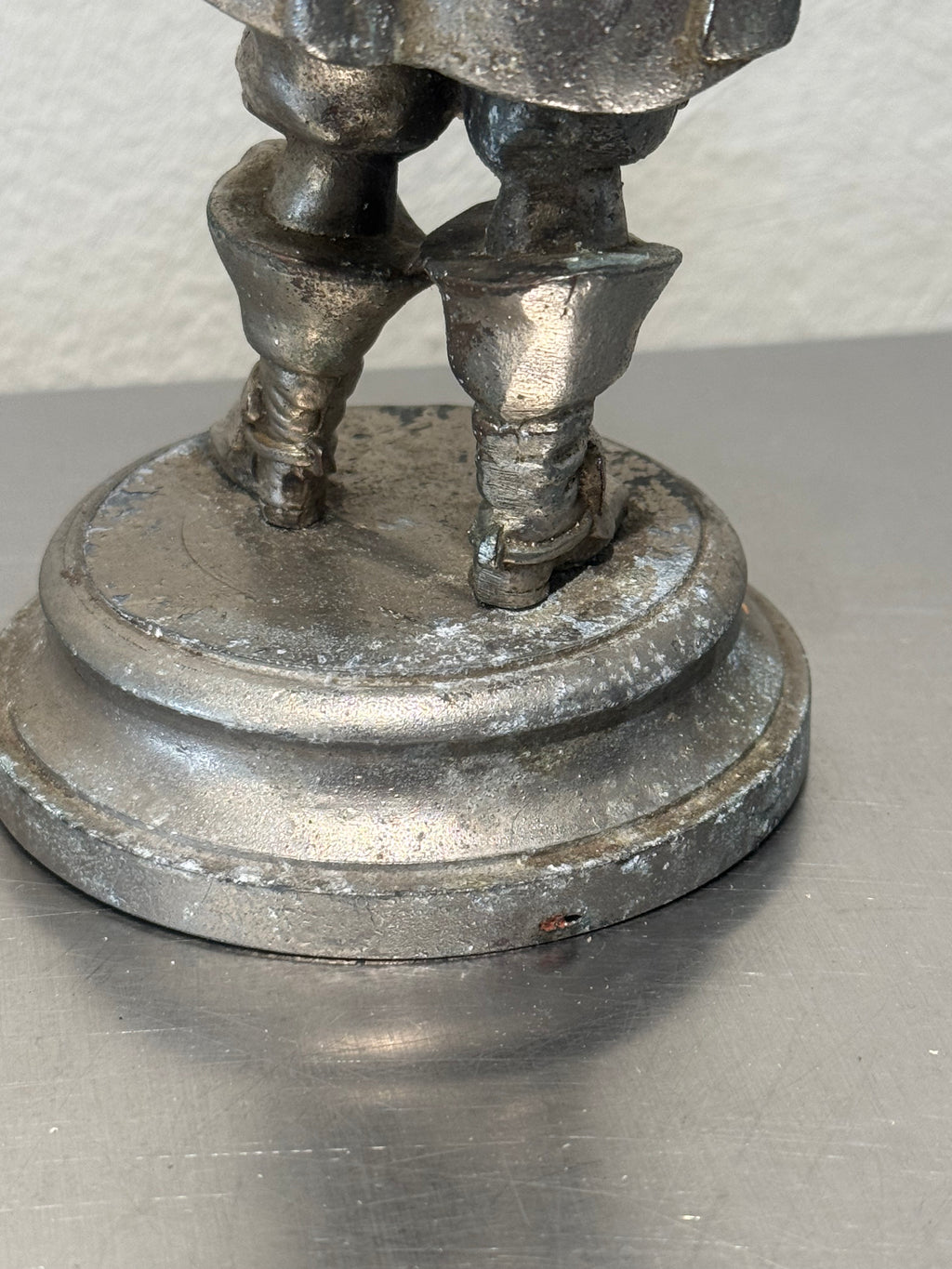 Vintage metal musketeer figure side view