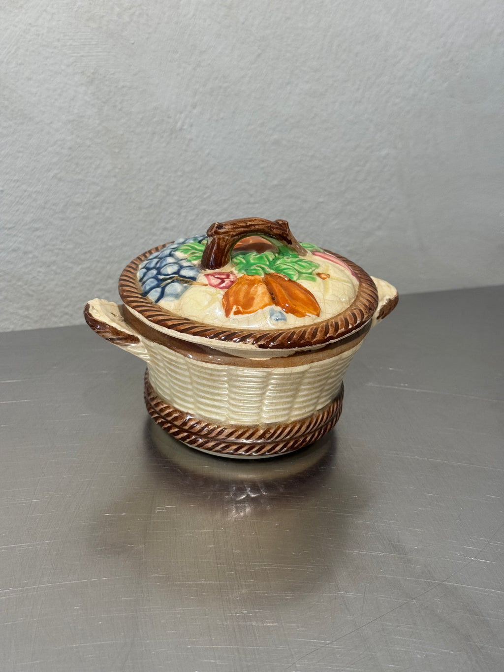 Vintage ceramic storage jar shaped like a fruit basket