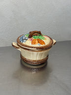 Vintage ceramic storage jar shaped like a fruit basket
