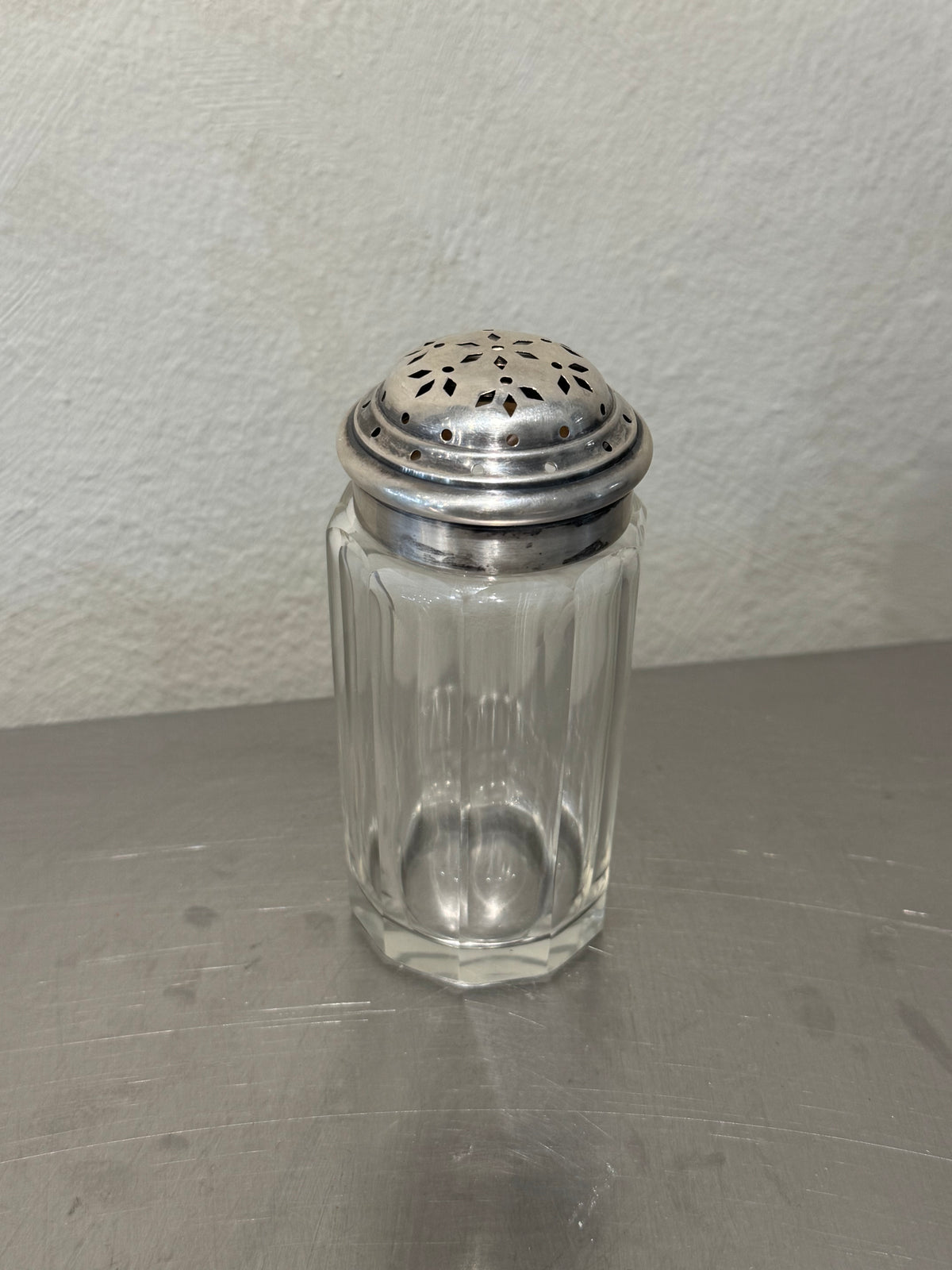 Antique crystal shakers with silver-plated lids