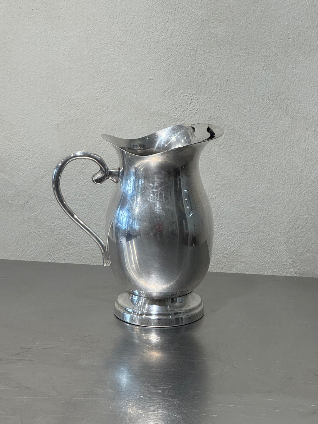Vintage silver-plated water pitcher detail