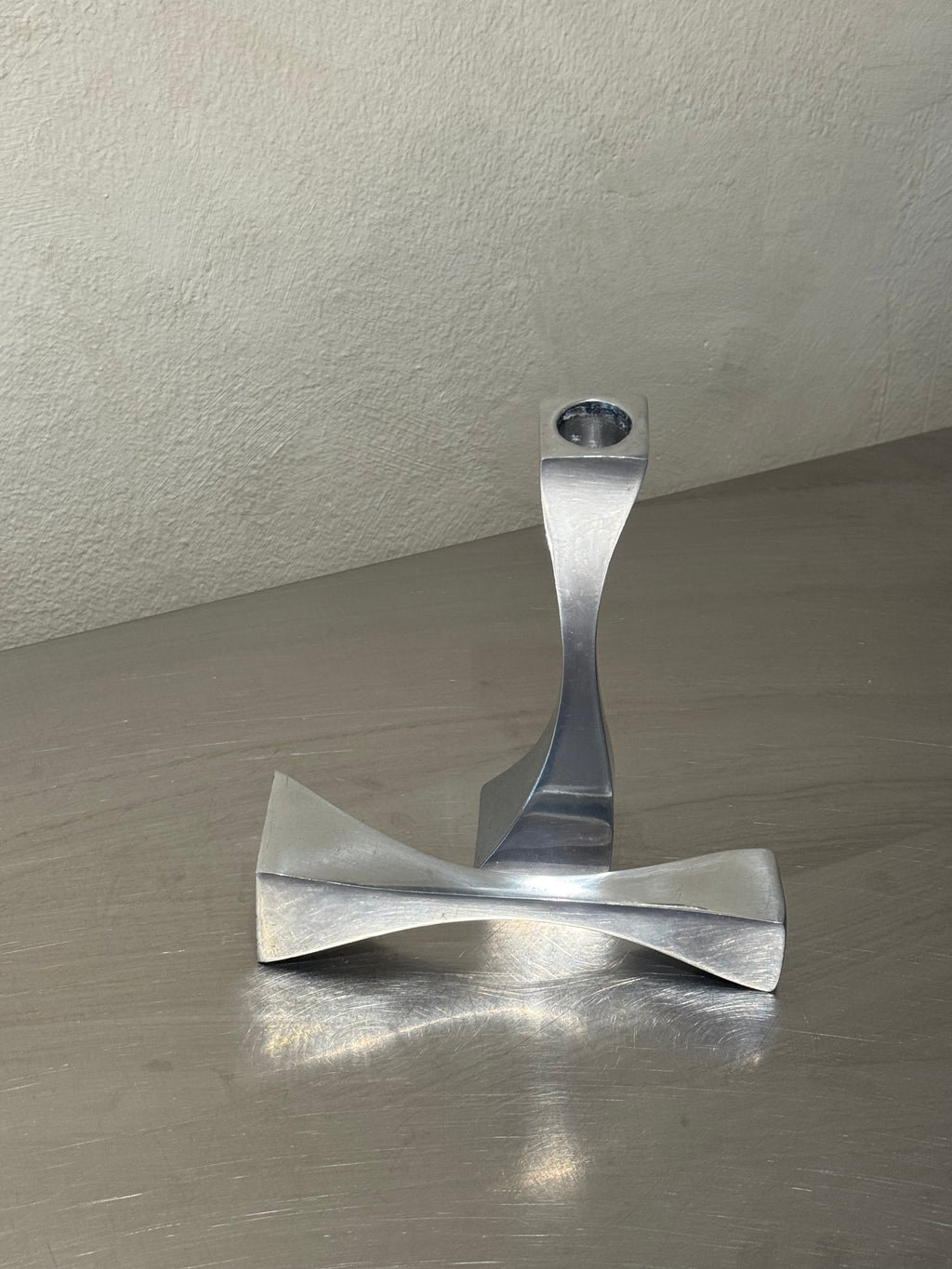 Sculptural wavy metal candlesticks side view