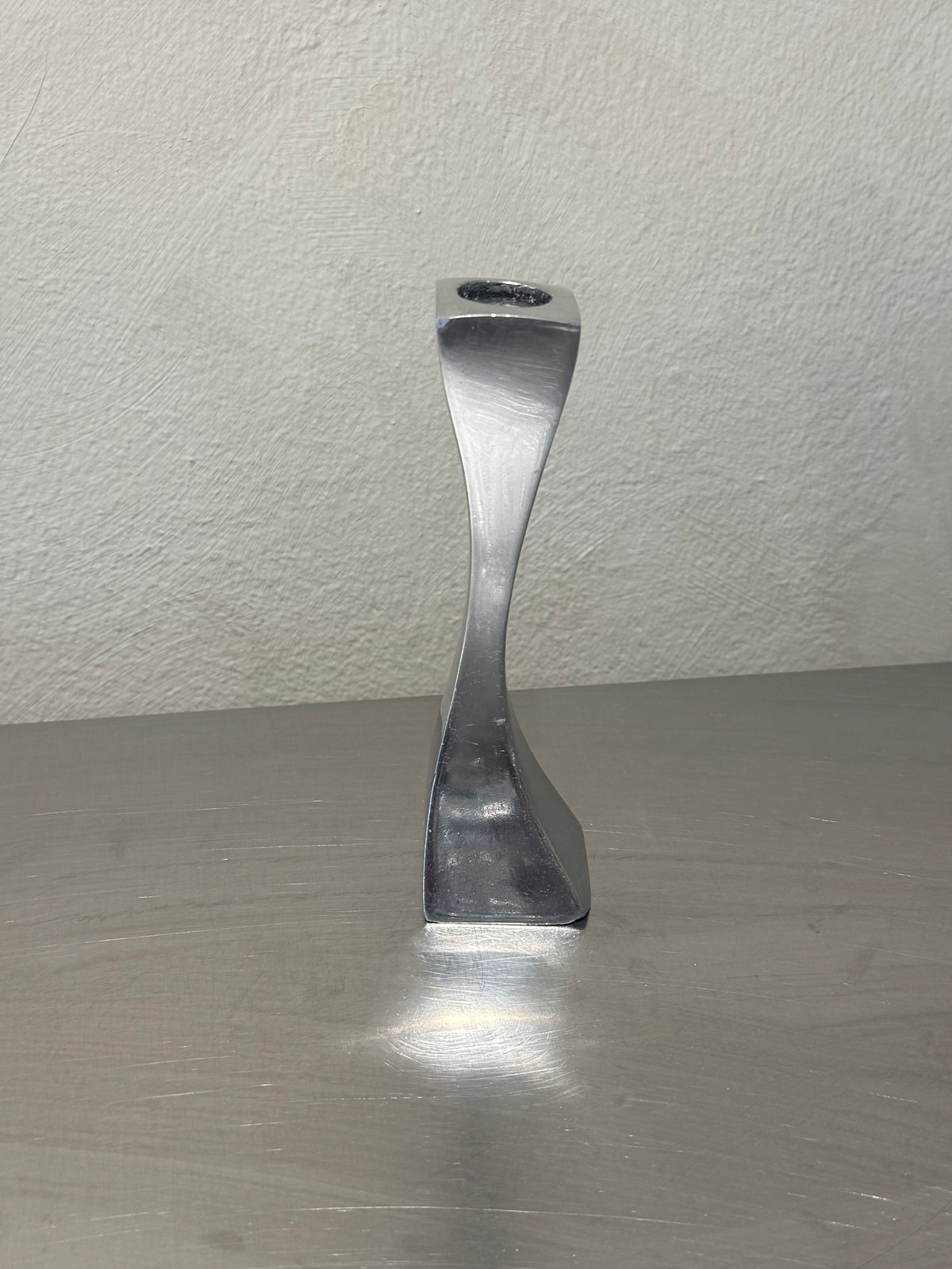 Polished metal candlesticks with twisted stems