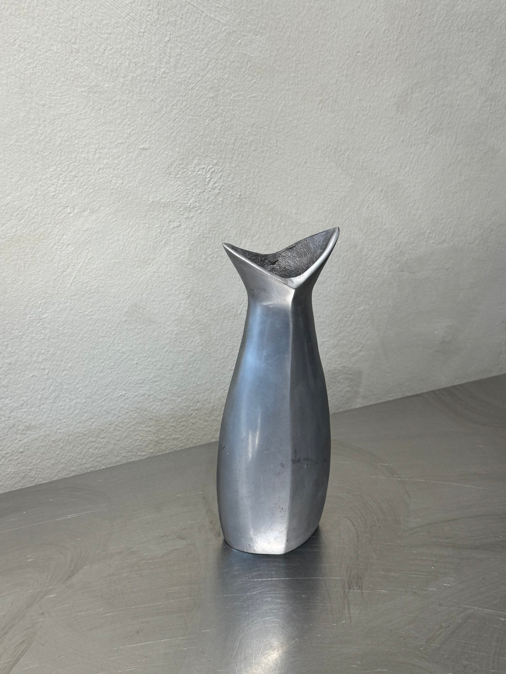 1980s polished metal vase detail