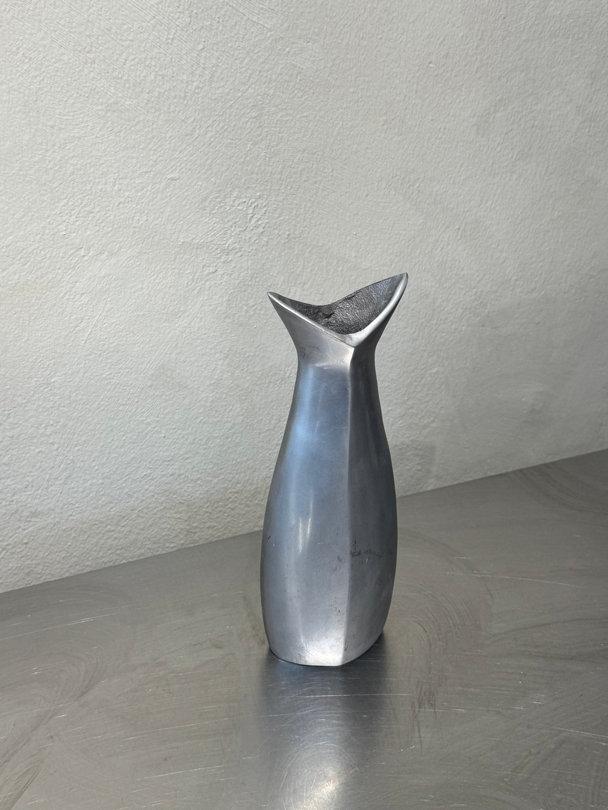 1980s polished metal vase detail