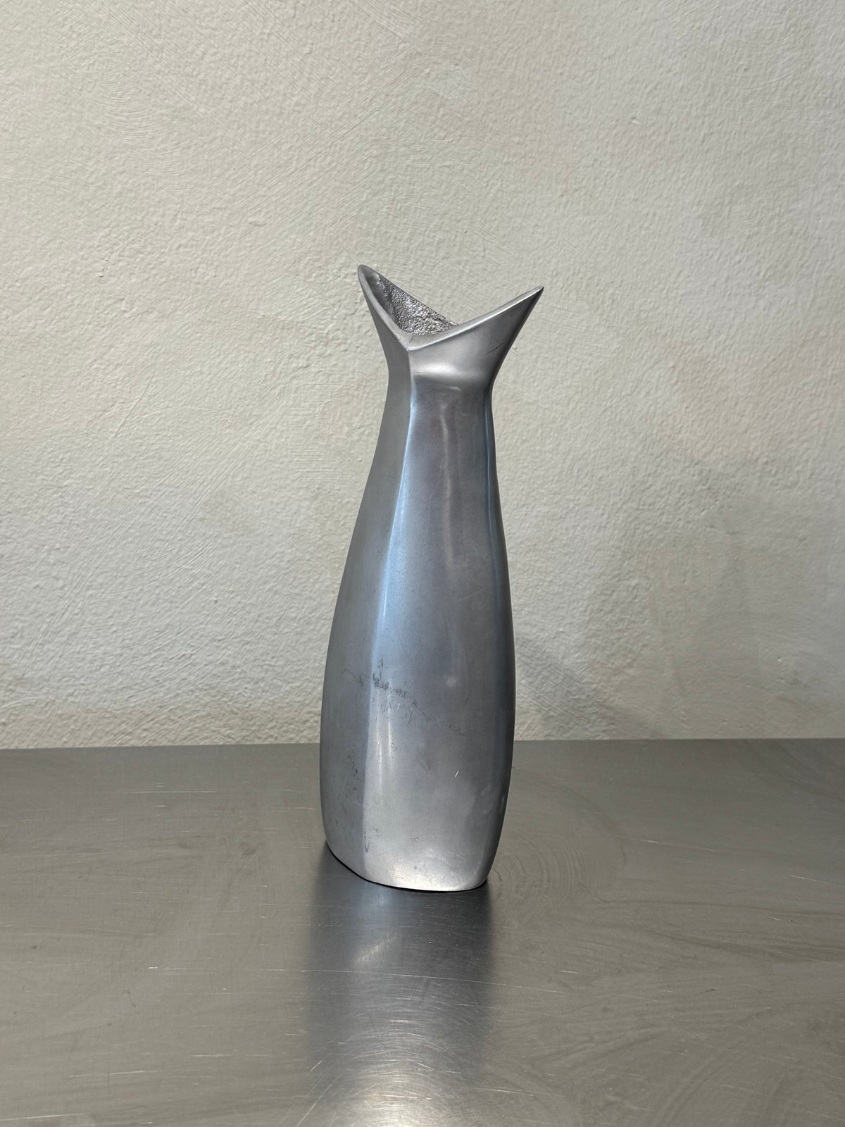 Tall vintage polished metal vase
