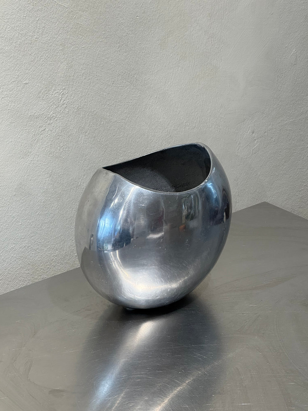 Rounded vintage polished metal vase