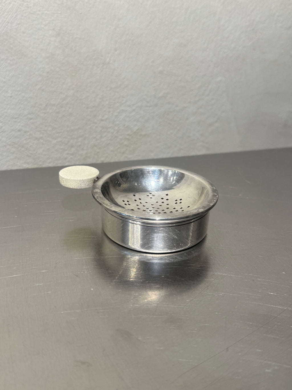 1930s silver-plated tea strainer with drip bowl