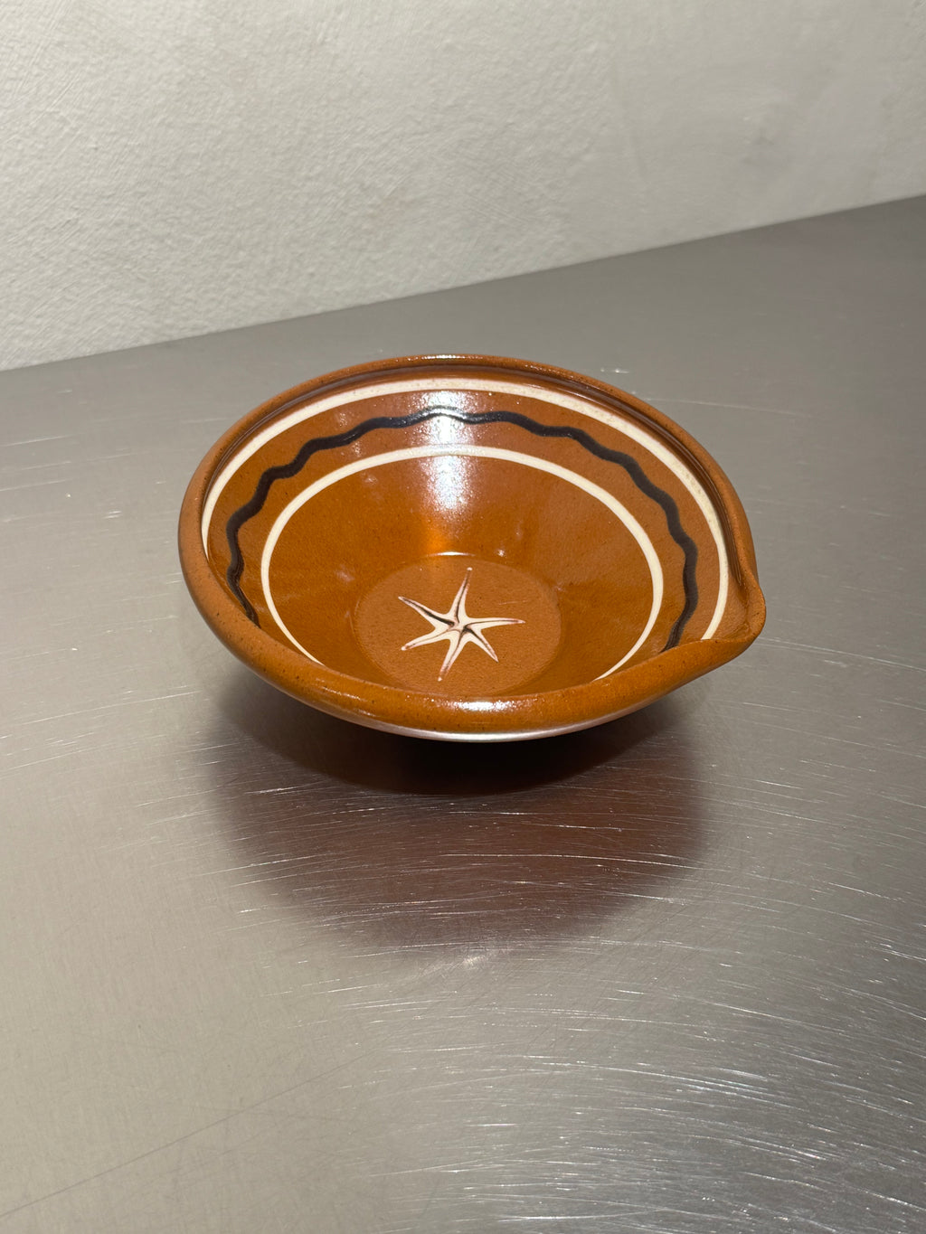 Glazed ceramic mixing bowl with pouring spout