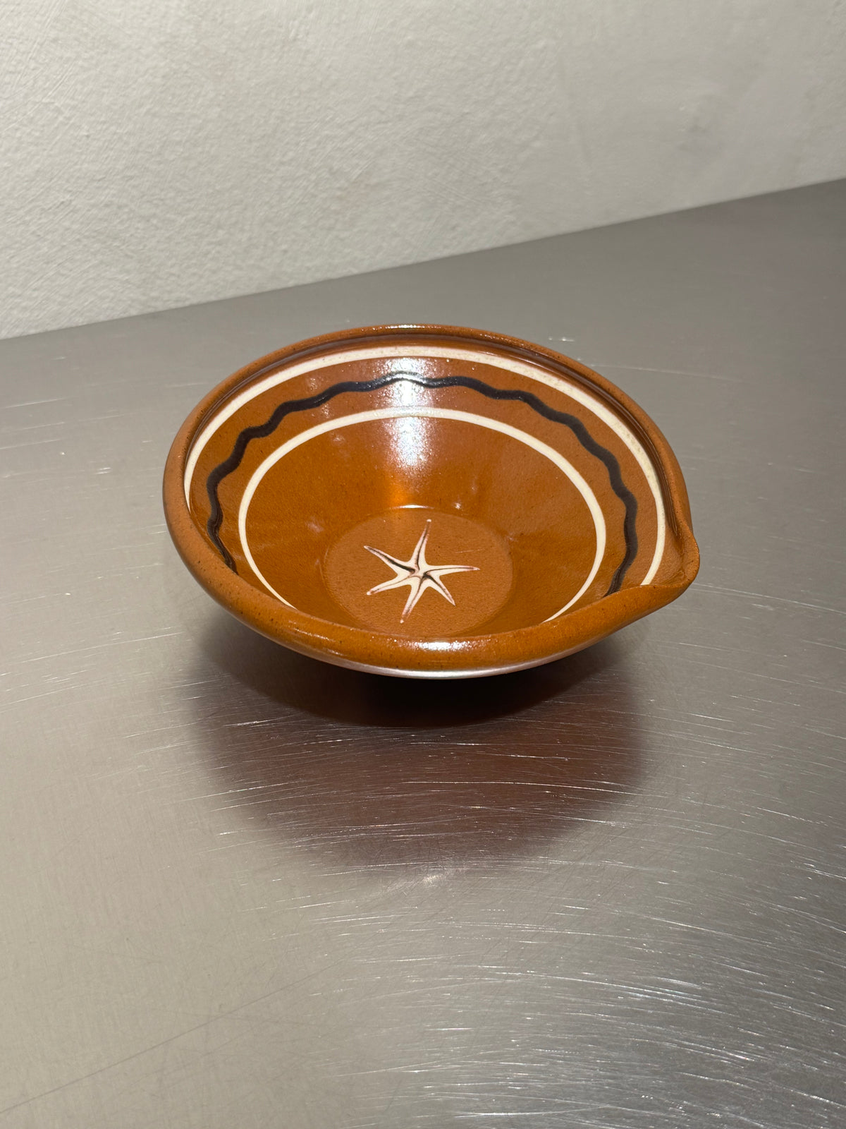 Glazed ceramic mixing bowl with pouring spout