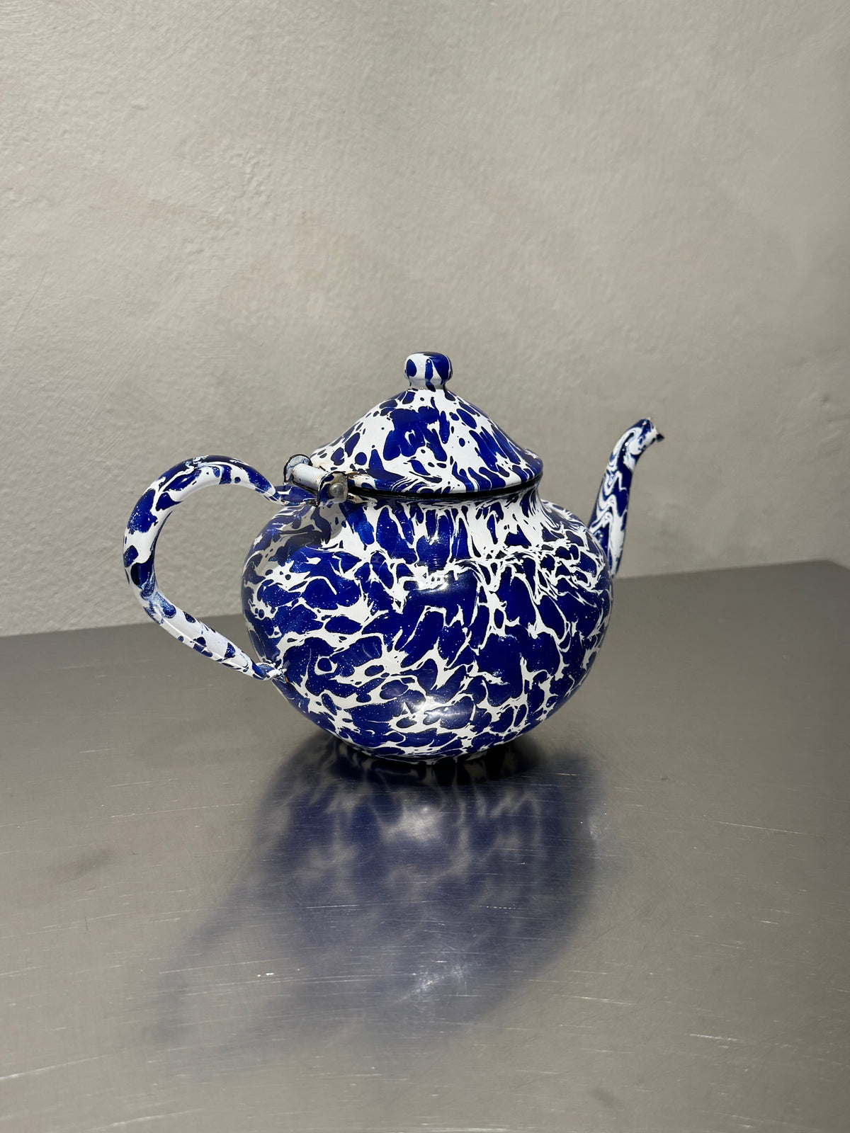 Antique enamel teapot with blue and white marbling