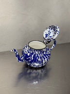 Antique enamel teapot detail with age wear