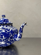 Blue and white marbled enamel teapot with chipped spout