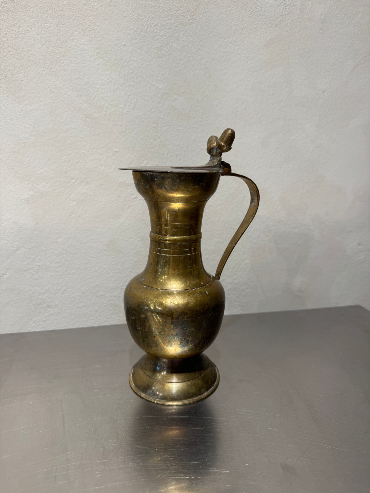 Rear view of antique brass pitcher