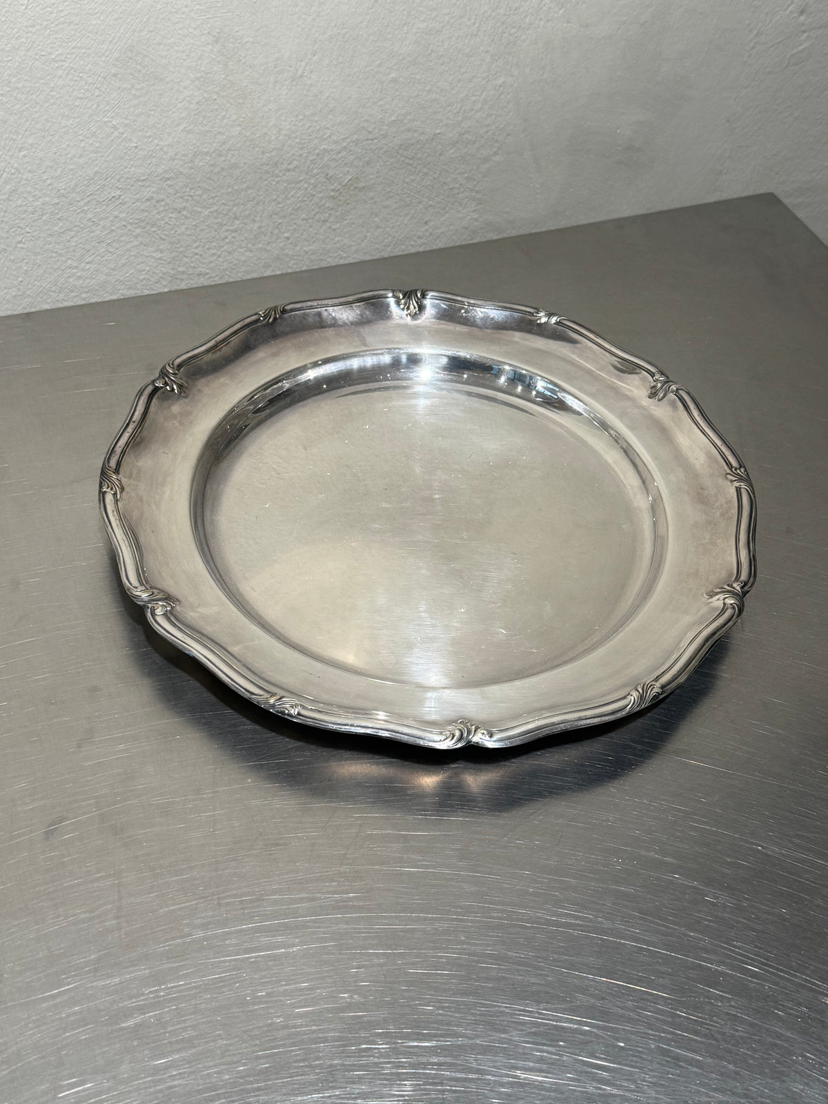 Round silver-plated tray with decorated border