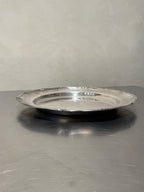 Side view of round silver-plated tray