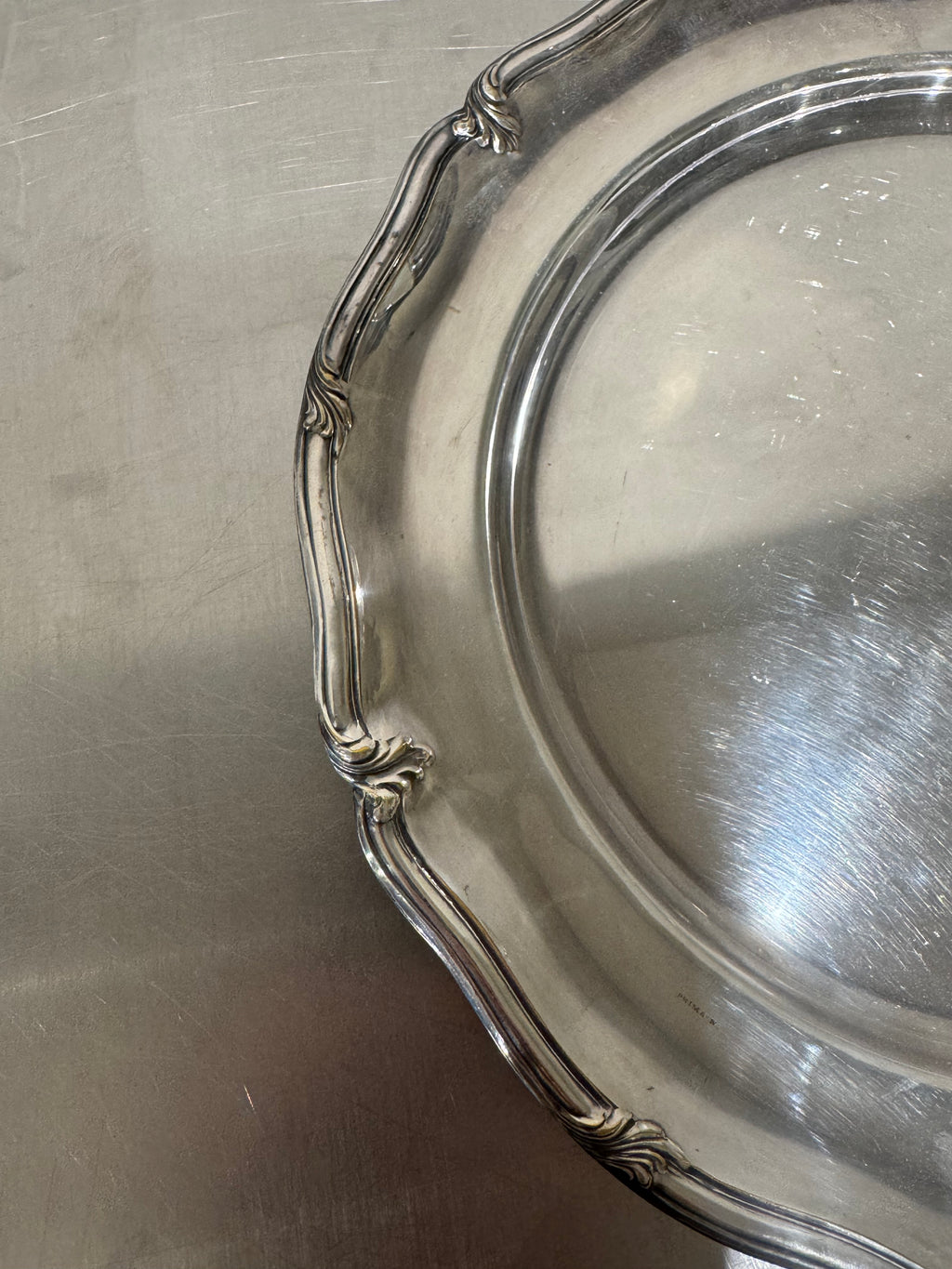 Detail of decorated border on silver-plated tray