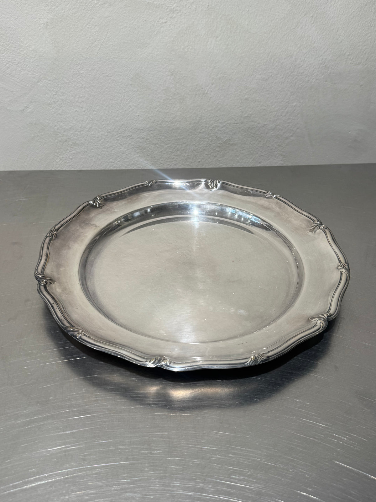 Front view of round silver-plated tray