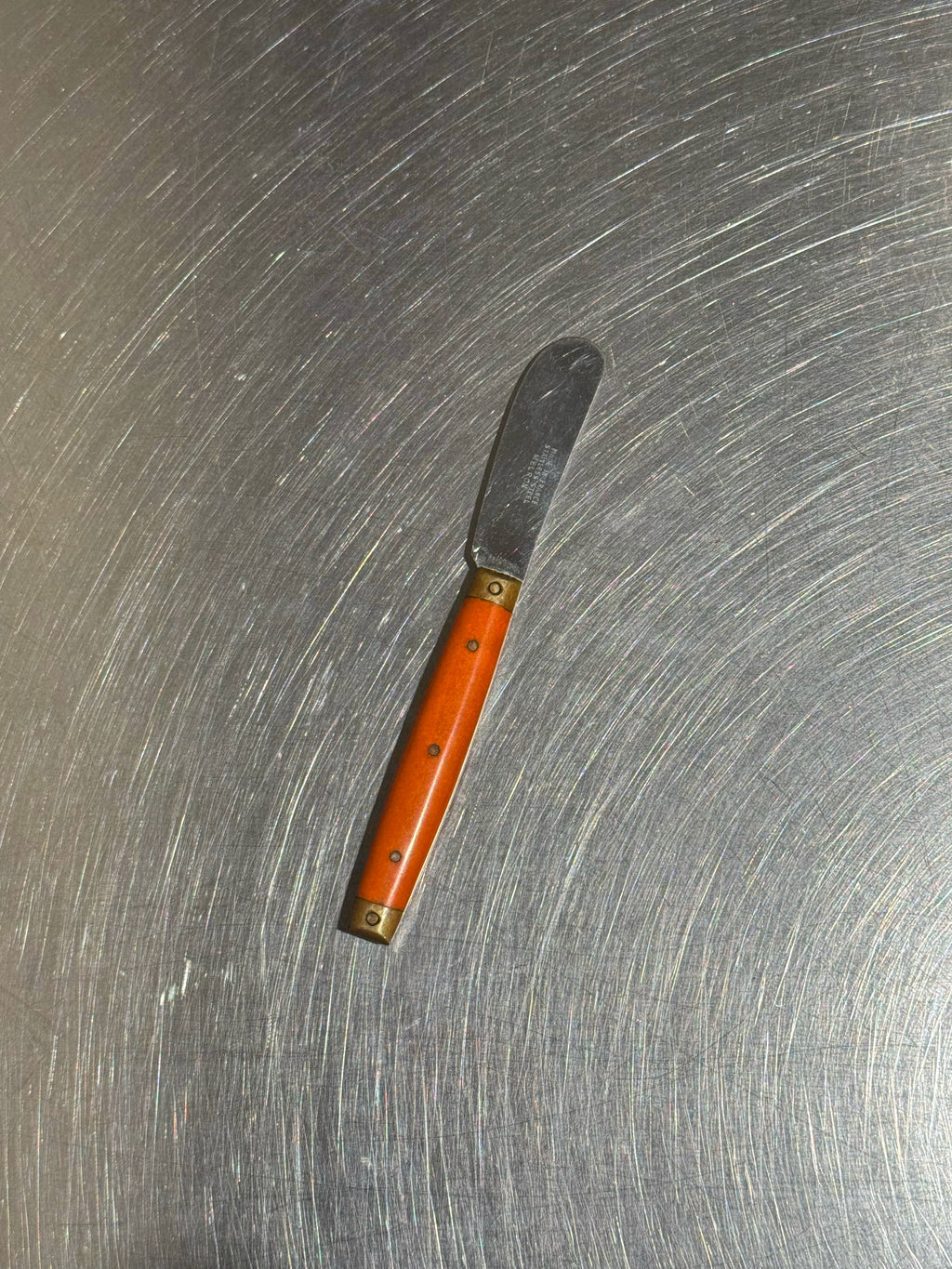 Orange Melron butter knife maker's mark