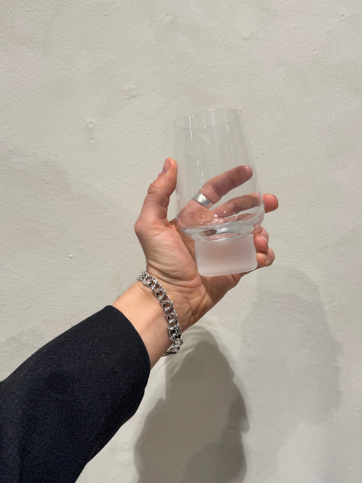 2000s tumbler with frosted foot held in hand